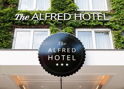 a sign for the altered hotel in front of a building at The Alfred Hotel in Amsterdam