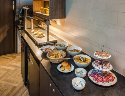 a buffet with many plates of food on a counter at The Alfred Hotel in Amsterdam