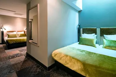 a hotel room with a bed and a mirror at The Alfred Hotel in Amsterdam