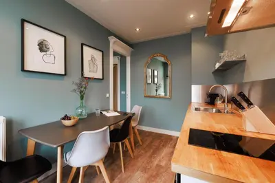 a kitchen and dining room with a table and chairs at Bloemendaal Hotel Collection Apartments in Bloemendaal