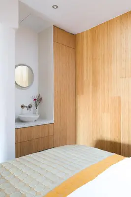 a bedroom with a bed and a sink at Kith & Kin Boutique Apartments in Amsterdam