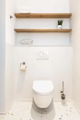 a bathroom with a white toilet in a room at Kith & Kin Boutique Apartments in Amsterdam