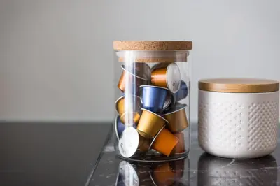 a glass jar filled with utensils on a counter at Kith & Kin Boutique Apartments in Amsterdam