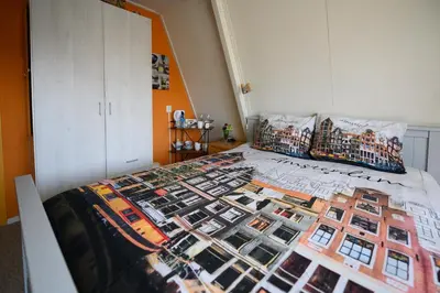 a bedroom with a bed with a collage of photos at Bed and Breakfast Ineke en John in Hoofddorp