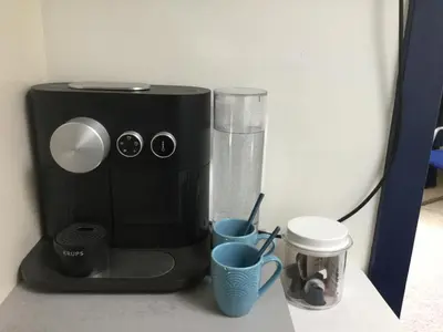a coffee maker sitting on a counter with two cups at Bed and Breakfast Ineke en John in Hoofddorp