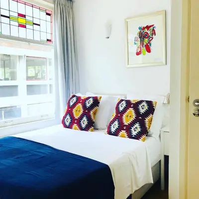 a bedroom with a bed with two pillows and a window at Mercedes Bed&Breakfast Amsterdam in Amsterdam