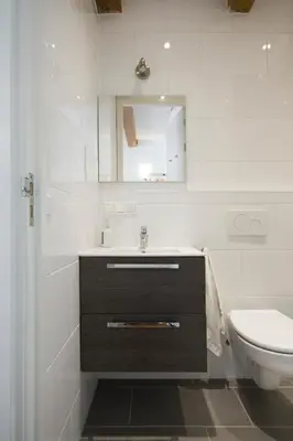 a bathroom with a sink and a toilet and a mirror at Mercedes Bed&Breakfast Amsterdam in Amsterdam