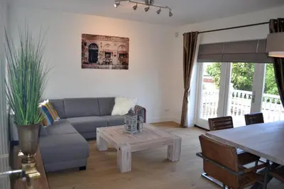a living room with a couch and a table at Residance Anne's Beach in Zandvoort