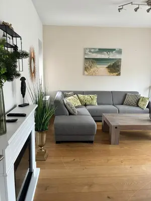 a living room with a couch and a coffee table at Residance Anne's Beach in Zandvoort