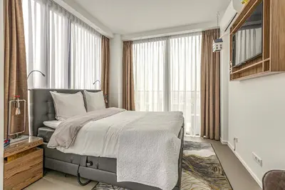 a bedroom with a bed and a large window at Black Jack Suites in Amsterdam
