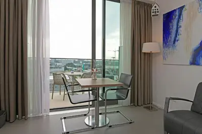 a room with a table and chairs and a large window at Black Jack Suites in Amsterdam