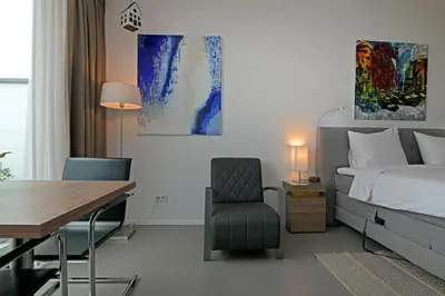 a bedroom with a bed and a desk and a chair at Black Jack Suites in Amsterdam