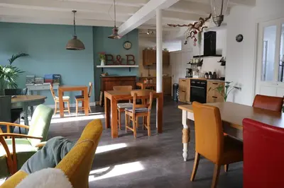 a kitchen and dining room with a table and chairs at B&B - Pension Het Oude Dorp in Katwijk