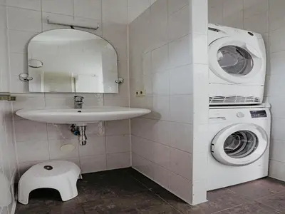 a bathroom with a washing machine and a sink at House by Uitgeestermeer with Garden in Uitgeest