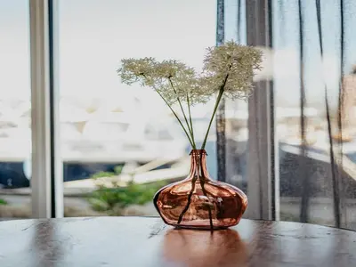 a vase with flowers in it sitting on a table at House by Uitgeestermeer with Garden in Uitgeest