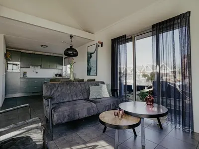 a living room with a couch and a table at House by Uitgeestermeer with Garden in Uitgeest