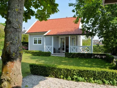 a white house with an orange roof at Holiday Home in Noordwijk near Beach in Noordwijk