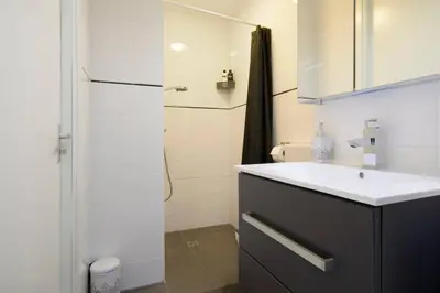a bathroom with a sink and a refrigerator at H 58 in Amsterdam