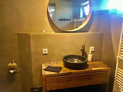 a bathroom with a sink and a mirror at Ferienhaus Glücklich am Meer 1 mit Wellnesszugang in Egmond aan Zee