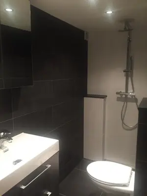 a bathroom with a toilet and a sink and a shower at Bridge Inn in Amsterdam