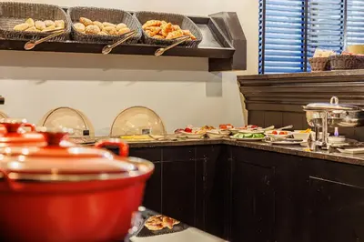 a kitchen with a counter with plates of food at Grand Hotel Alkmaar in Alkmaar