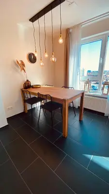 a dining room with a wooden table and chairs at @Juliette in Zandvoort