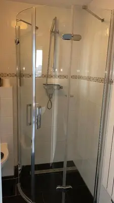 a shower with a glass door in a bathroom at @Juliette in Zandvoort