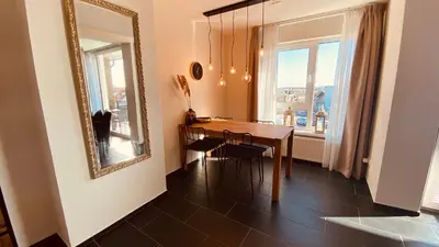 a dining room with a table and a mirror at @Juliette in Zandvoort