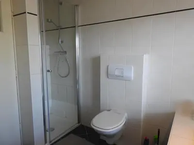 a bathroom with a toilet and a shower at MY-A-Mi-Go-S in Muiderberg