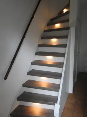 a staircase with wood floors and white railings at MY-A-Mi-Go-S in Muiderberg