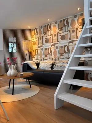 a living room with a couch and a table at Huisje 16 in Noordwijk aan Zee