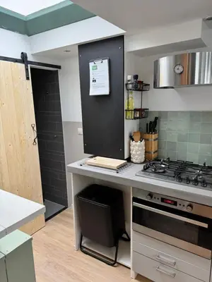 a kitchen with a stove and a counter top at Huisje 16 in Noordwijk aan Zee