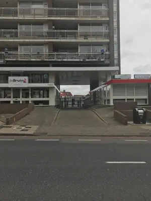 an empty parking lot in front of a building at Huisje 16 in Noordwijk aan Zee