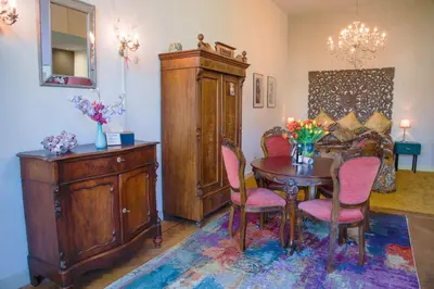 a dining room with a table and chairs and a cabinet at B&B Het Hart van Haarlem in Haarlem