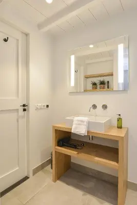 a bathroom with a sink and a mirror at Endless Summer Beach Apartments in Zandvoort