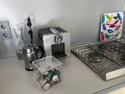 a kitchen counter with a toaster next to a stove at Bergen Holiday Home in Schoorl