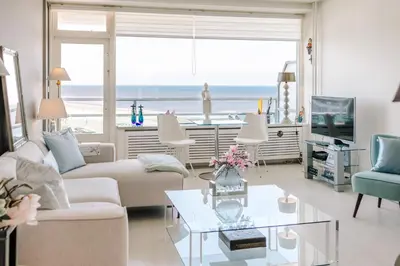 a living room with a view of the ocean at Dare to be different in Zandvoort