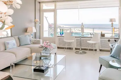 a living room with a couch and a table at Dare to be different in Zandvoort