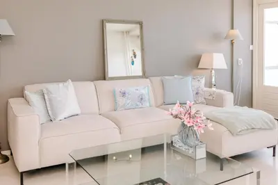 a living room with a couch and a table at Dare to be different in Zandvoort
