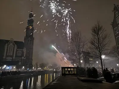 a fireworks display in front of a building with a clock tower at Prince Royal B&B in Amsterdam