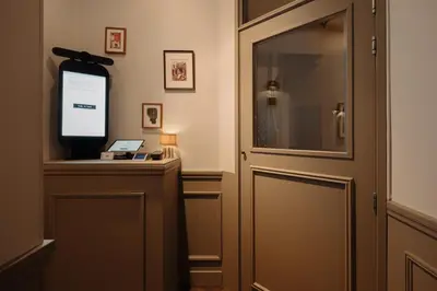 a room with a door and a television on a desk at Adam Downtown in Amsterdam