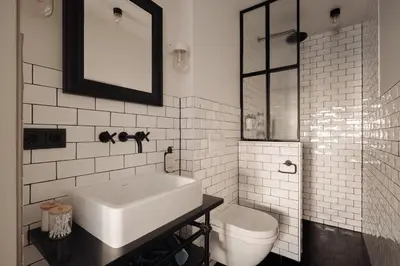 a white bathroom with a sink and a toilet at Adam Downtown in Amsterdam