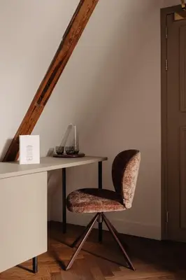a desk and a chair in a room with a staircase at Adam Downtown in Amsterdam
