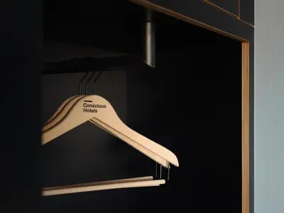a wooden spatula is hanging on a shelf at Conscious Hotel The Tire Station in Amsterdam