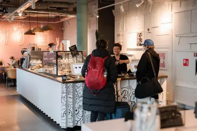 a group of people standing at a counter at Conscious Hotel The Tire Station in Amsterdam