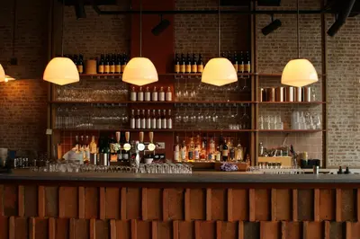 a bar with a lot of bottles of alcohol at Conscious Hotel The Tire Station in Amsterdam