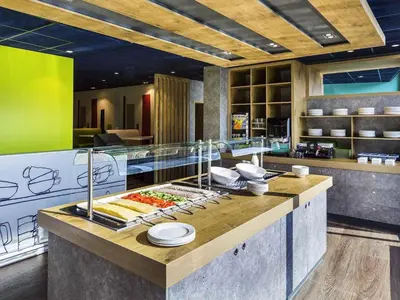 a kitchen with a counter with food on it at ibis budget Amsterdam City South in Amstelveen