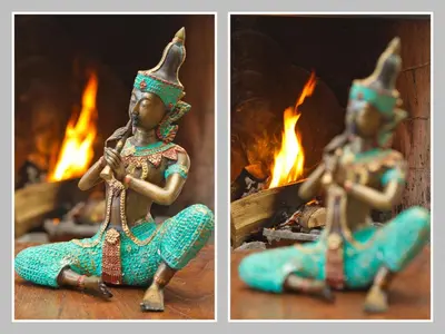 a statue of a woman sitting in front of a fireplace at Hövell in Huizen