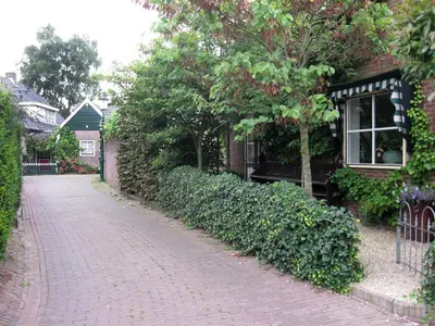 a brick road in front of a house at Hövell in Huizen