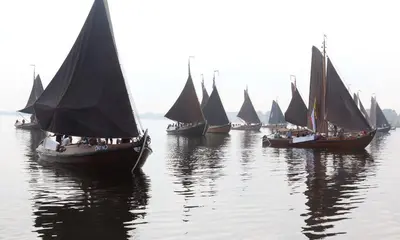 a group of sailboats floating in the water at Hövell in Huizen